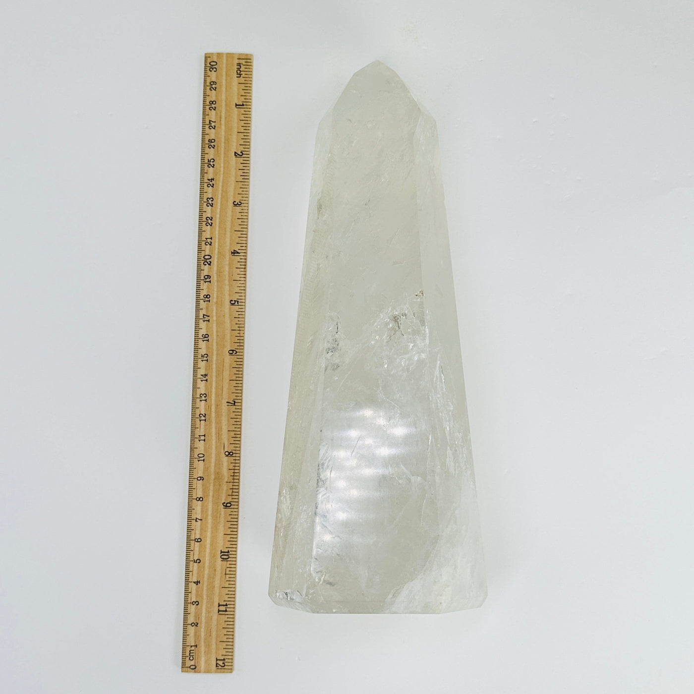Crystal Quartz polished tower next to a ruler for size reference