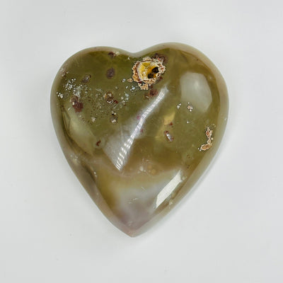 backside of natural agate druzy heart on white background