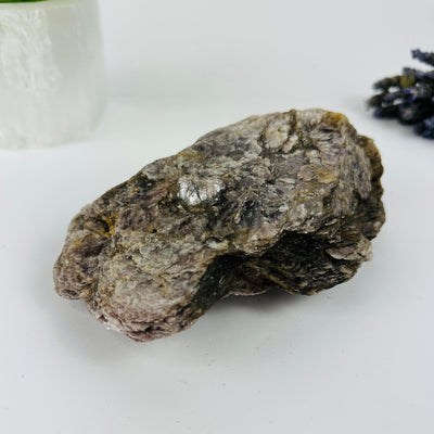 lepidolite mica with decorations in the background