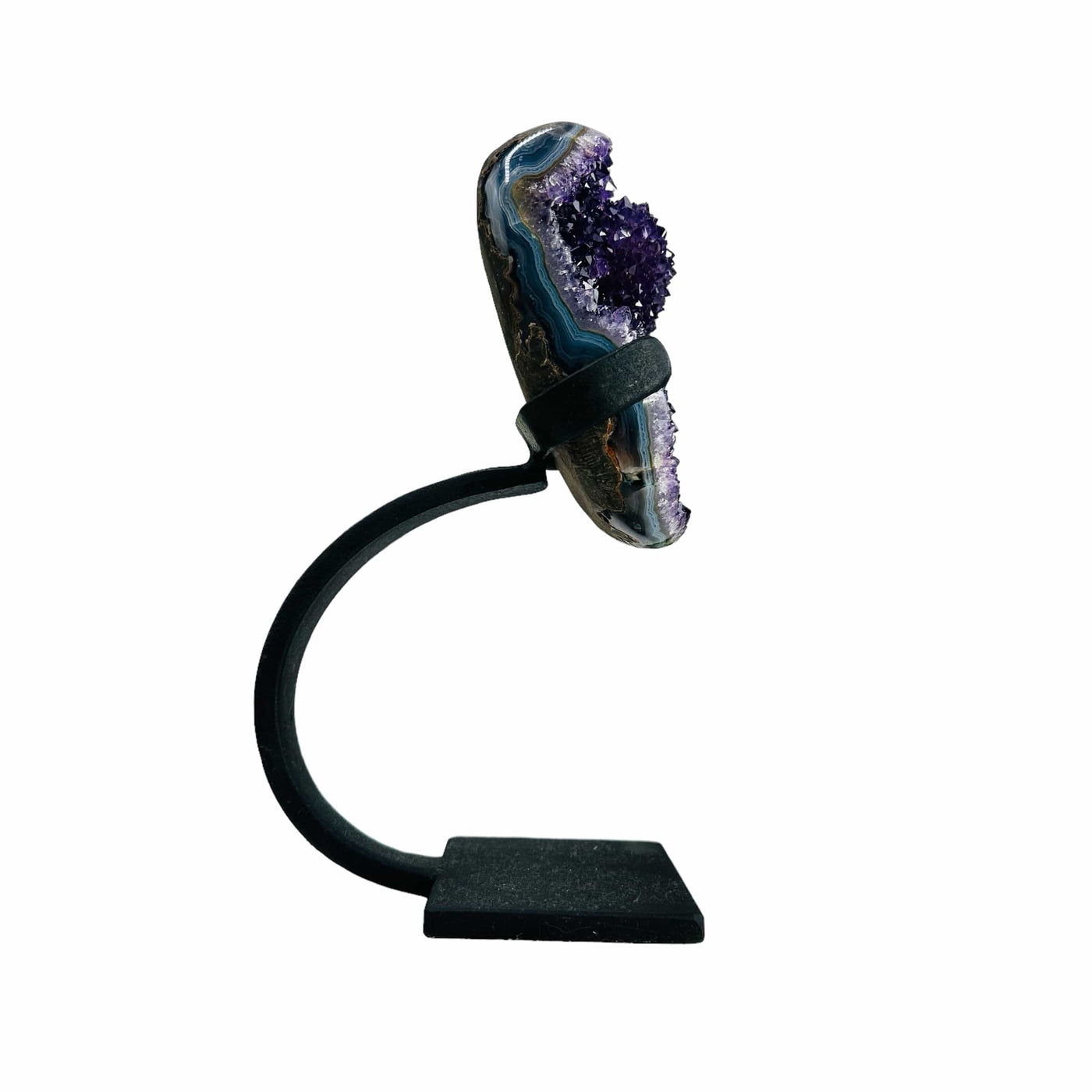 purple amethyst on metal stand on white background