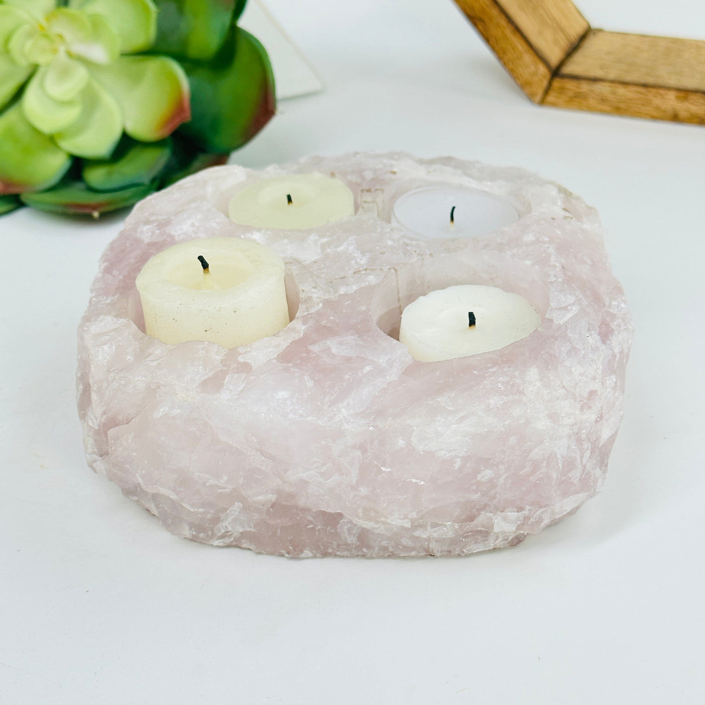 rose quartz candle holder with decorations in the background