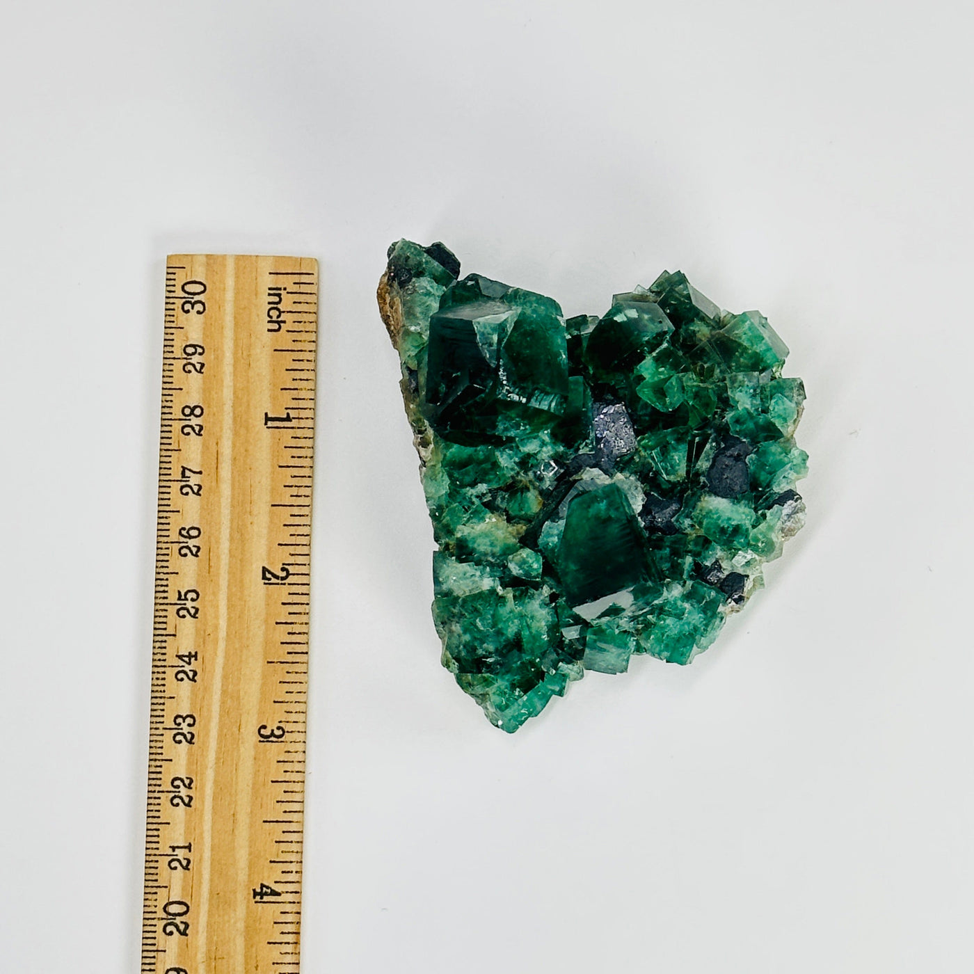 cubic fluorite next to a ruler for size reference