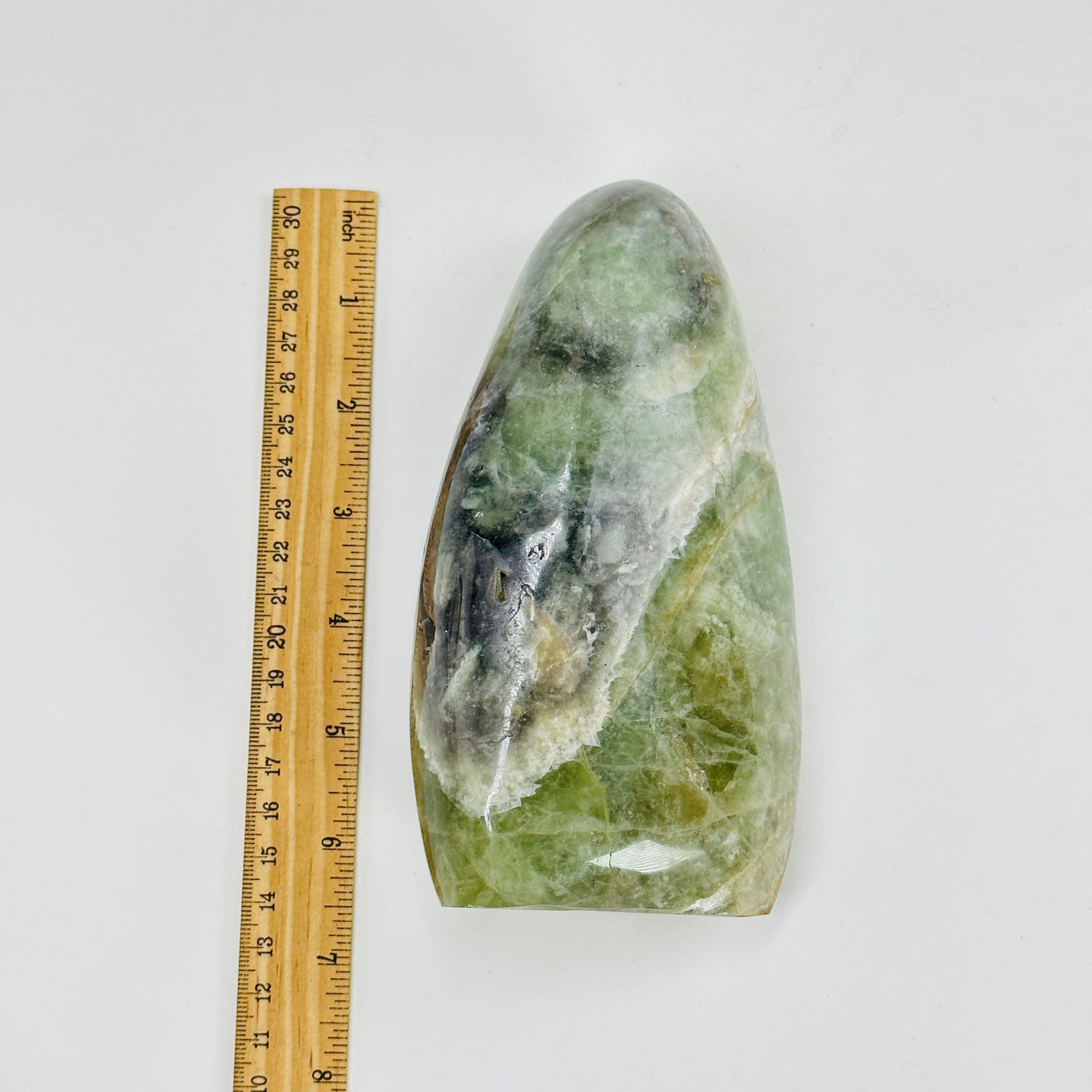 fluorite polished cutbase next to a ruler for size reference