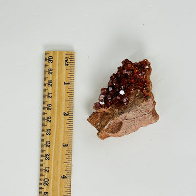 vanadinite next to a ruler for size reference