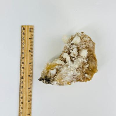 dogtooth calcite freeform next to a ruler for size reference