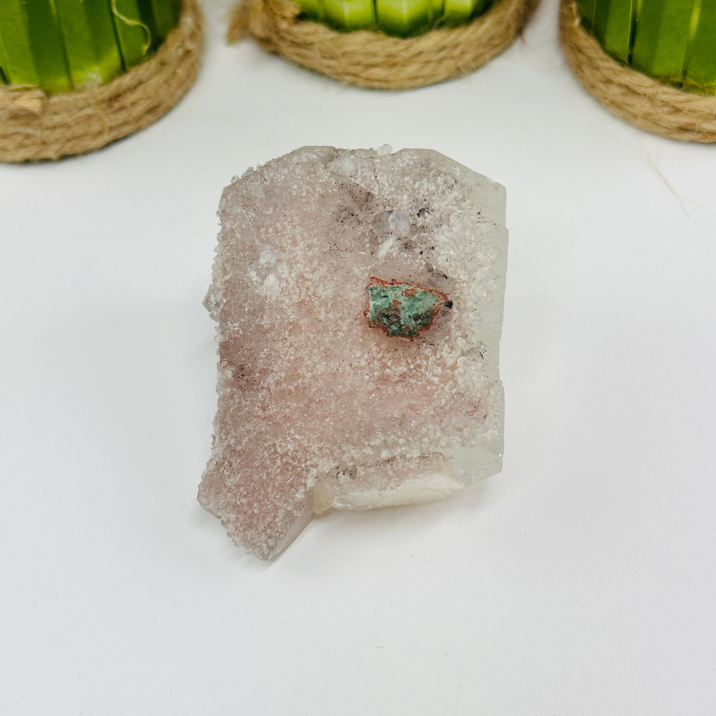 apophyllite cluster with decorations in the background