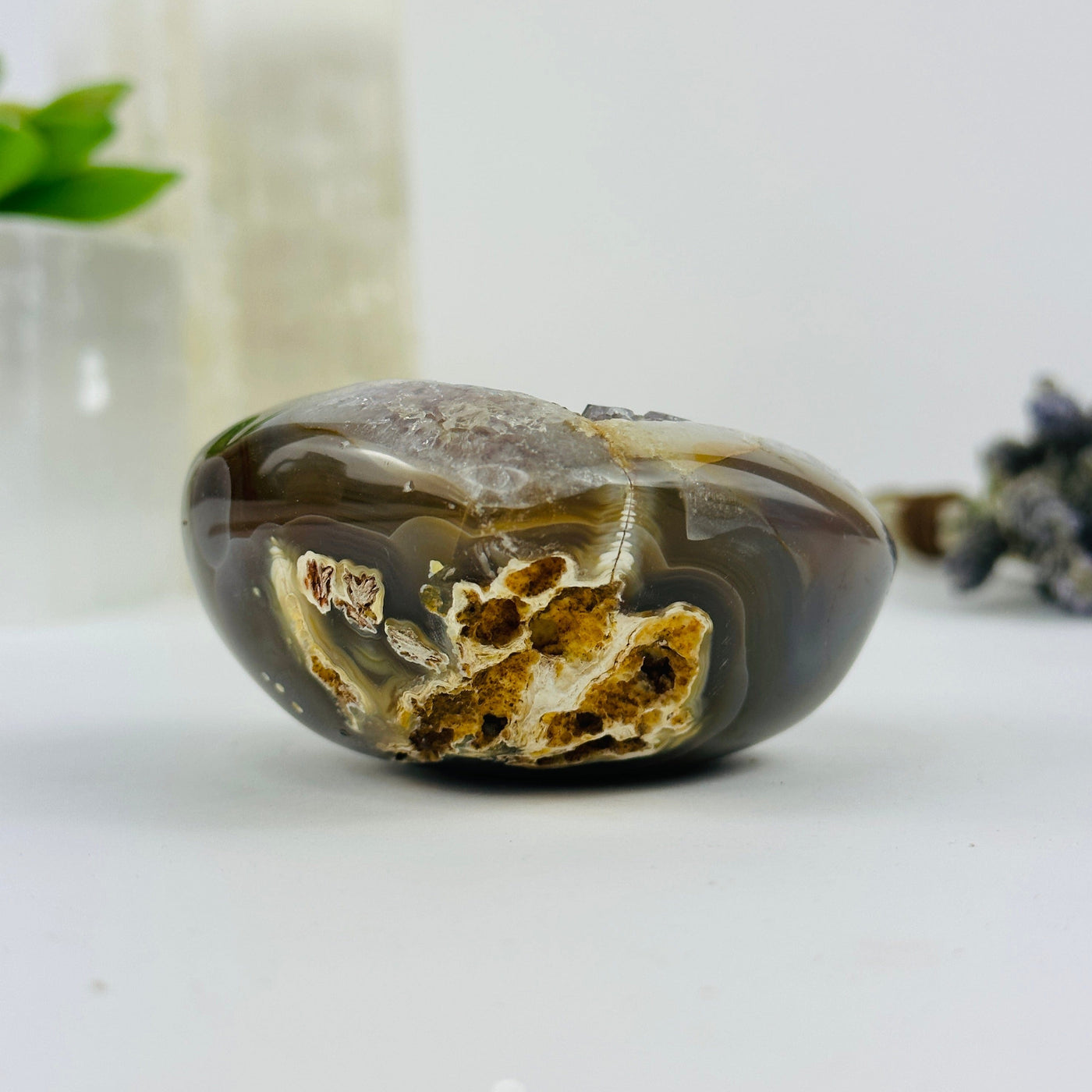 side view of agate heart with decorations in the background
