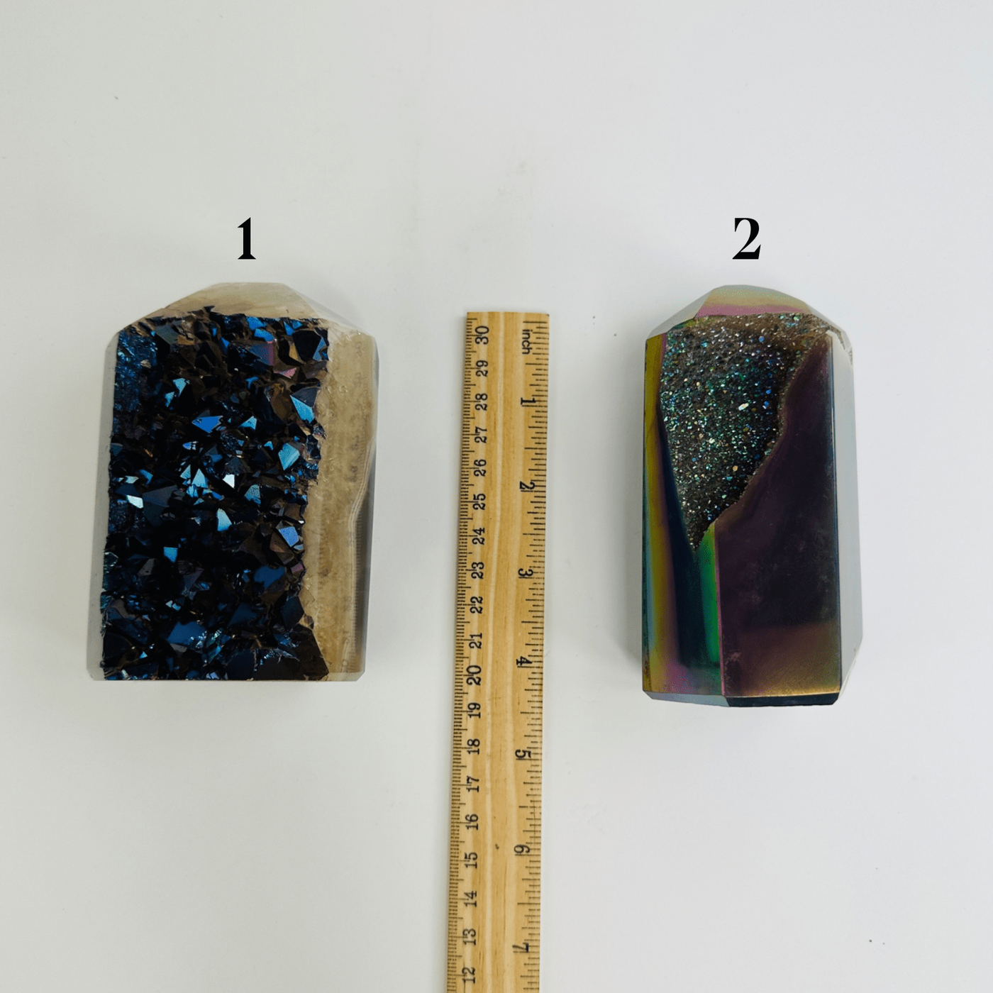 variant 1 of rainbow titanium coated agate points next to a ruler for size reference