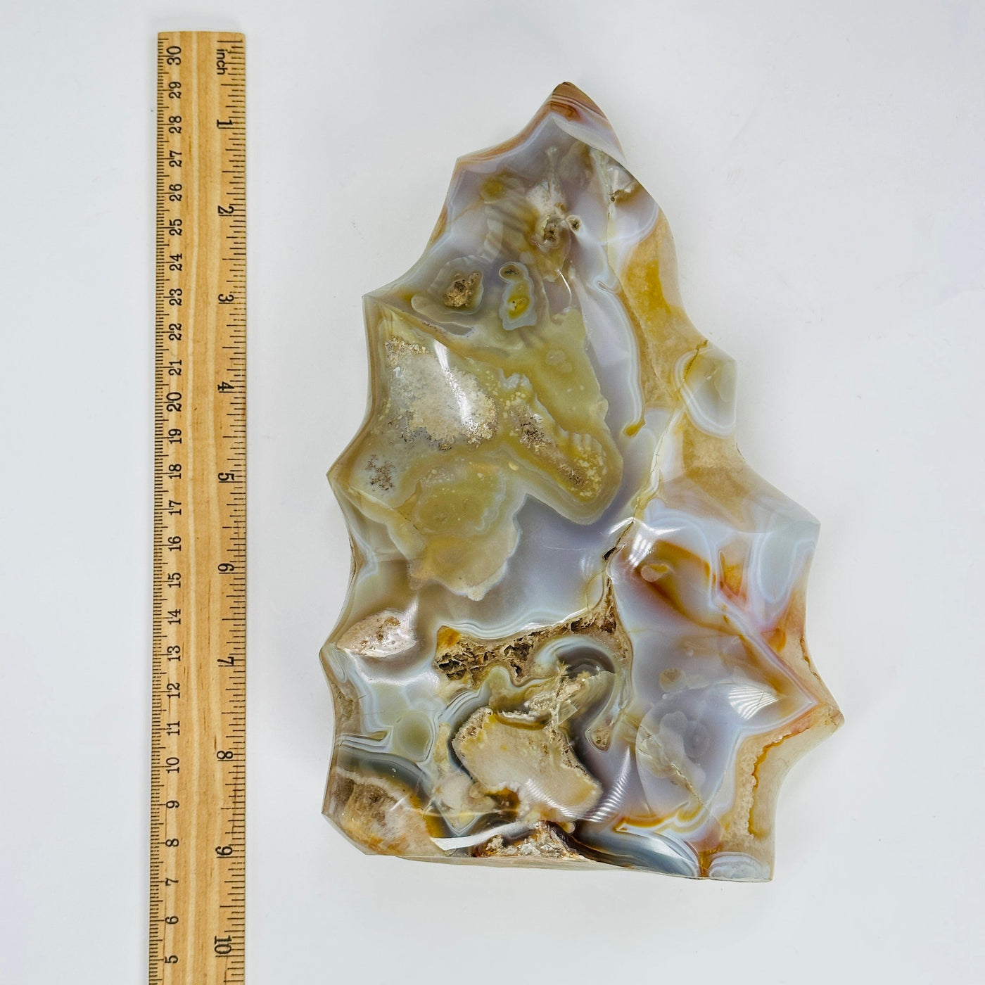 agate flame tower next to a ruler for size reference