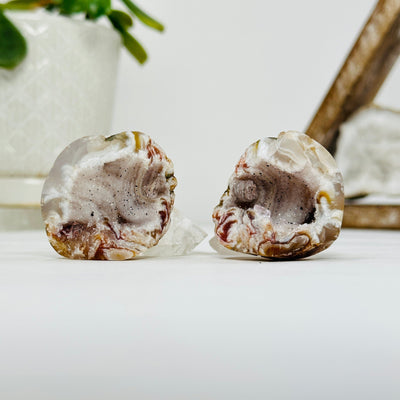 polished geode pieces with decorations in the background
