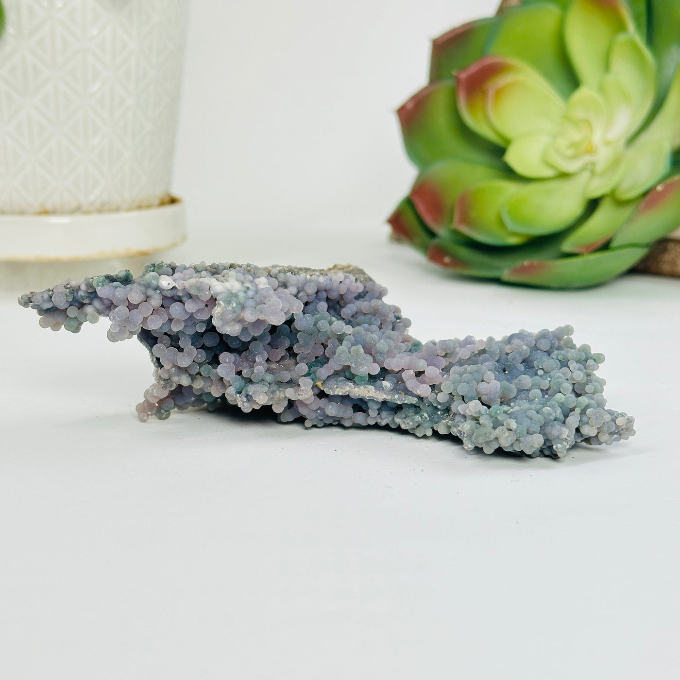 grape agate cluster with decorations in the background