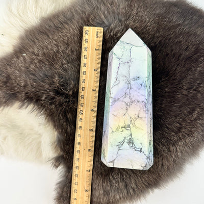 White howlite aura tower next to a ruler for size reference