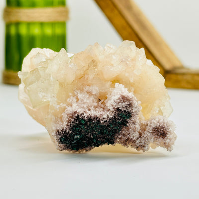 apophyllite with calcite with decorations in the background