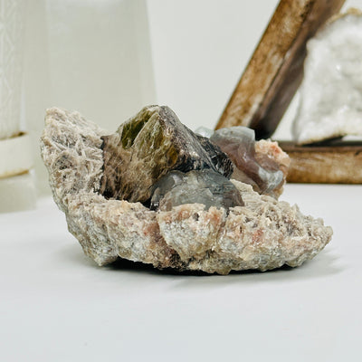 topaz with polylithionite with decorations in the background
