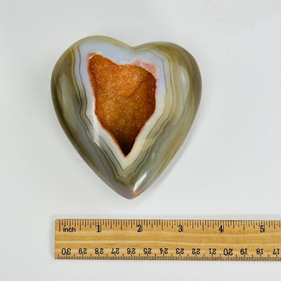natural agate druzy heart next to a ruler for size reference