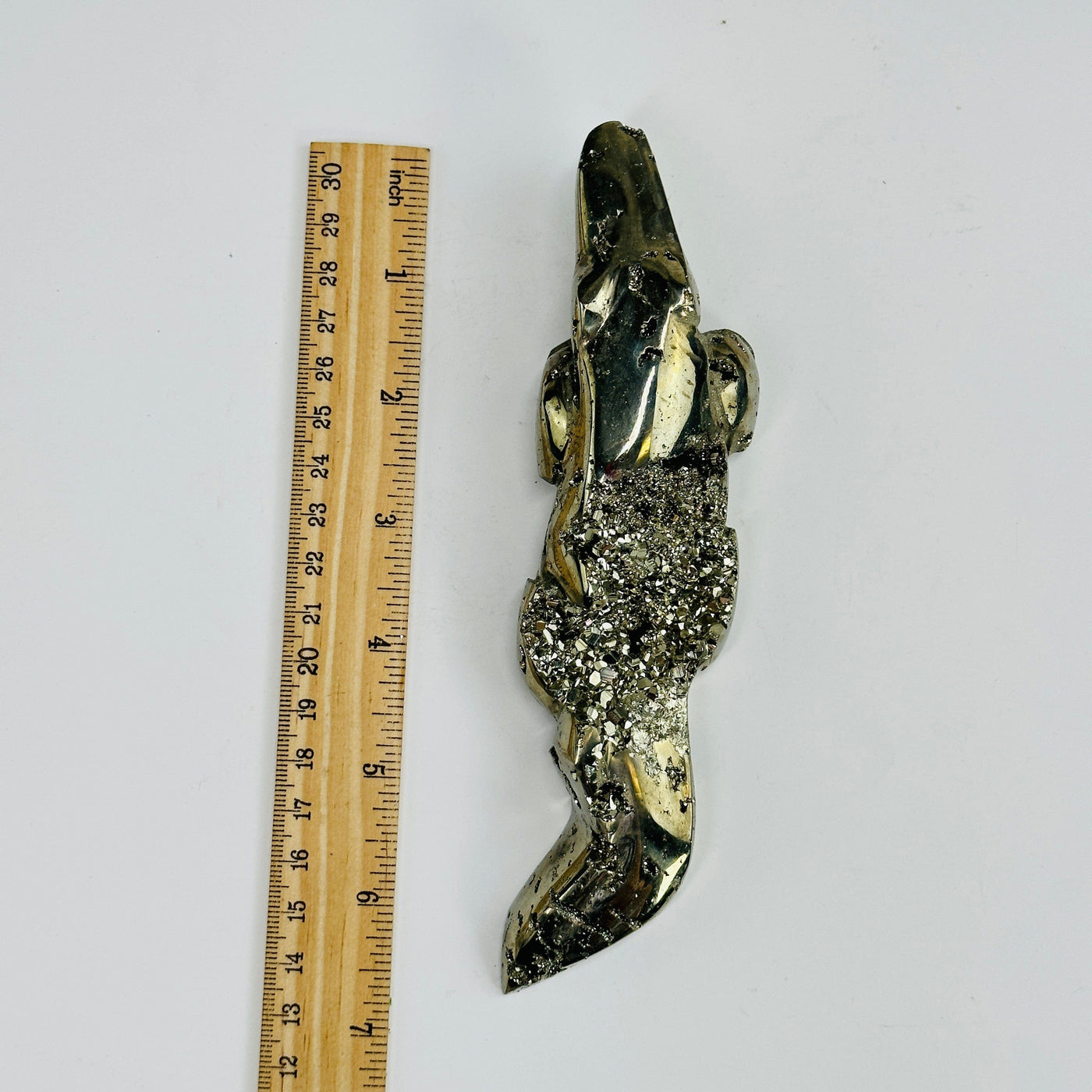 pyrite alligator next to a ruler for size reference