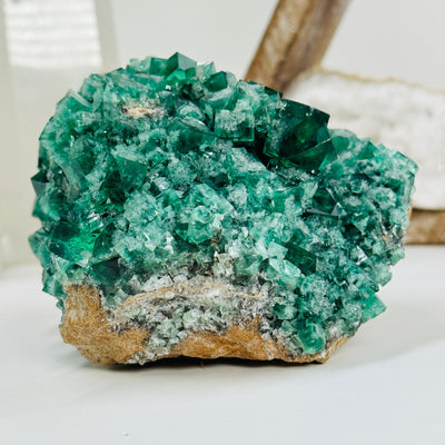fluorite formation cluster with decorations in the background