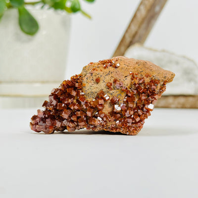 natural vanadinite formation with decorations in the background