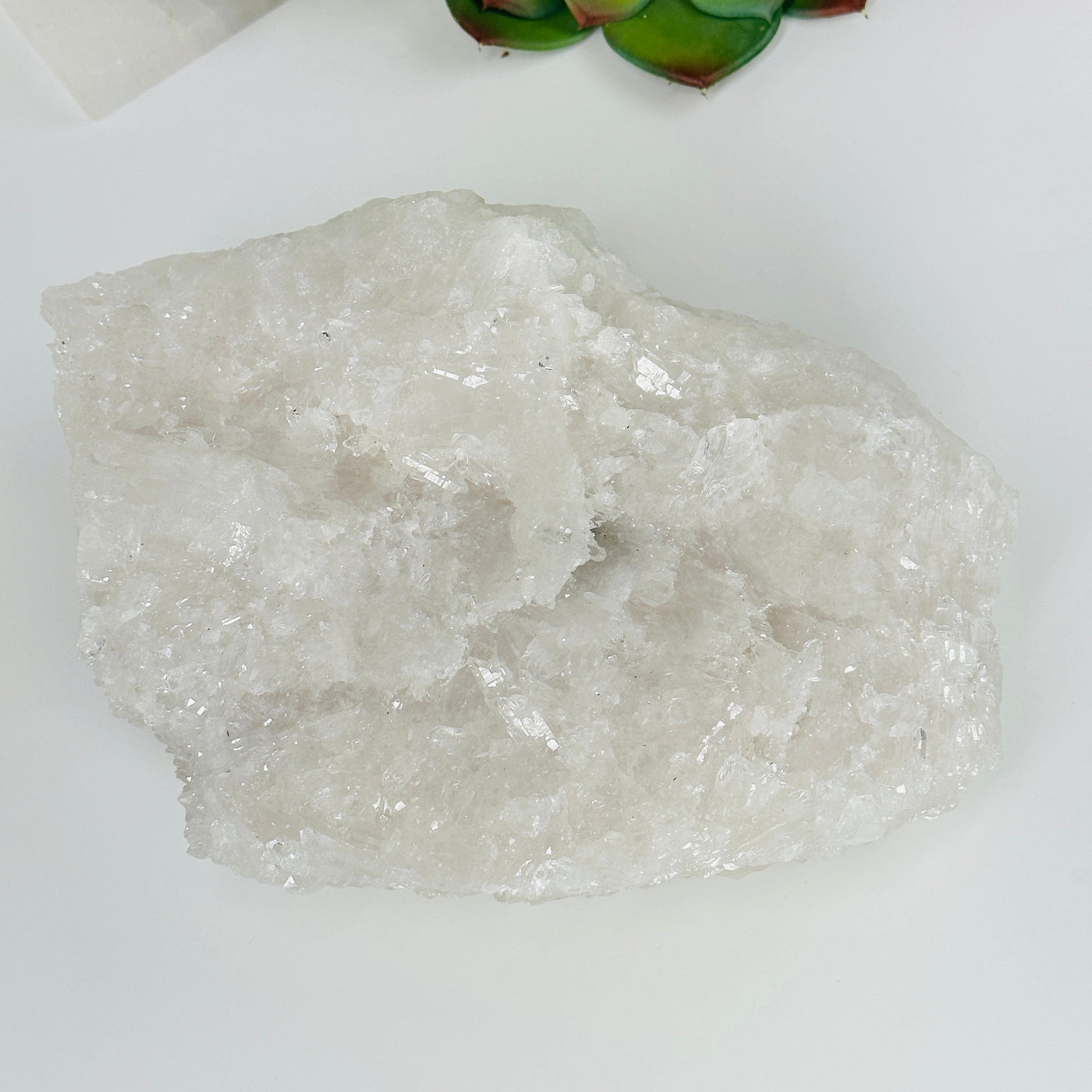 crystal quartz cluster with decorations in the background