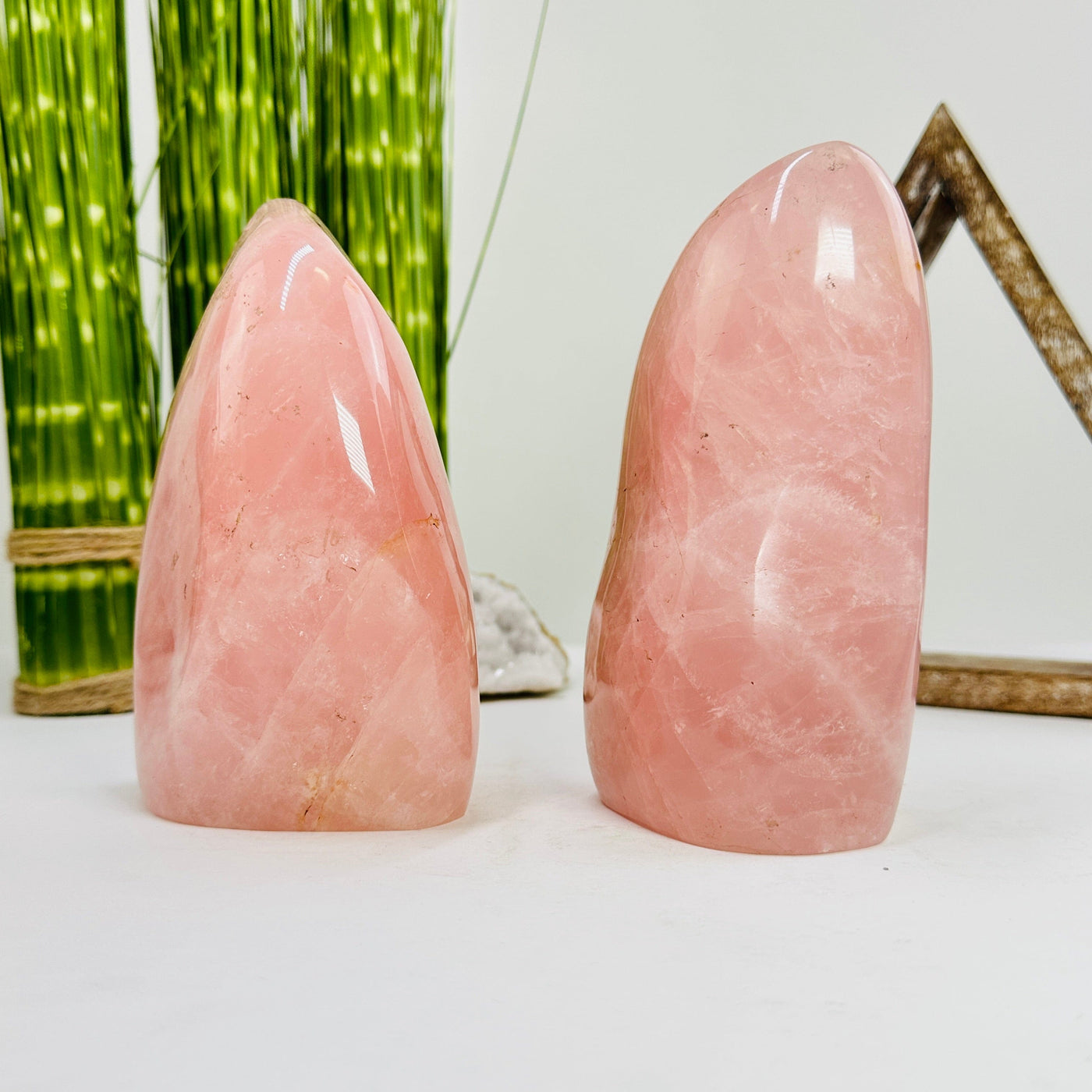 side view of rose quartz polished cutbases with decorations in the background