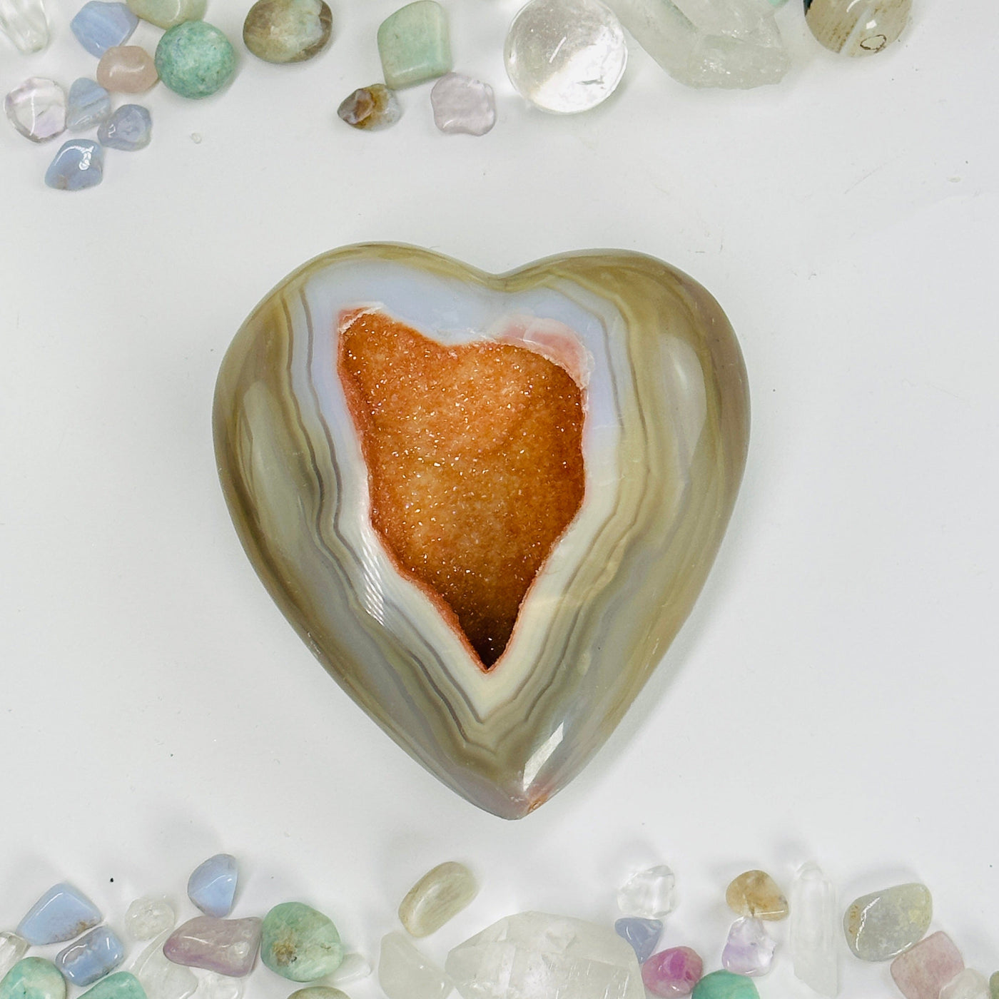 natural agate druzy heart with decorations in the background