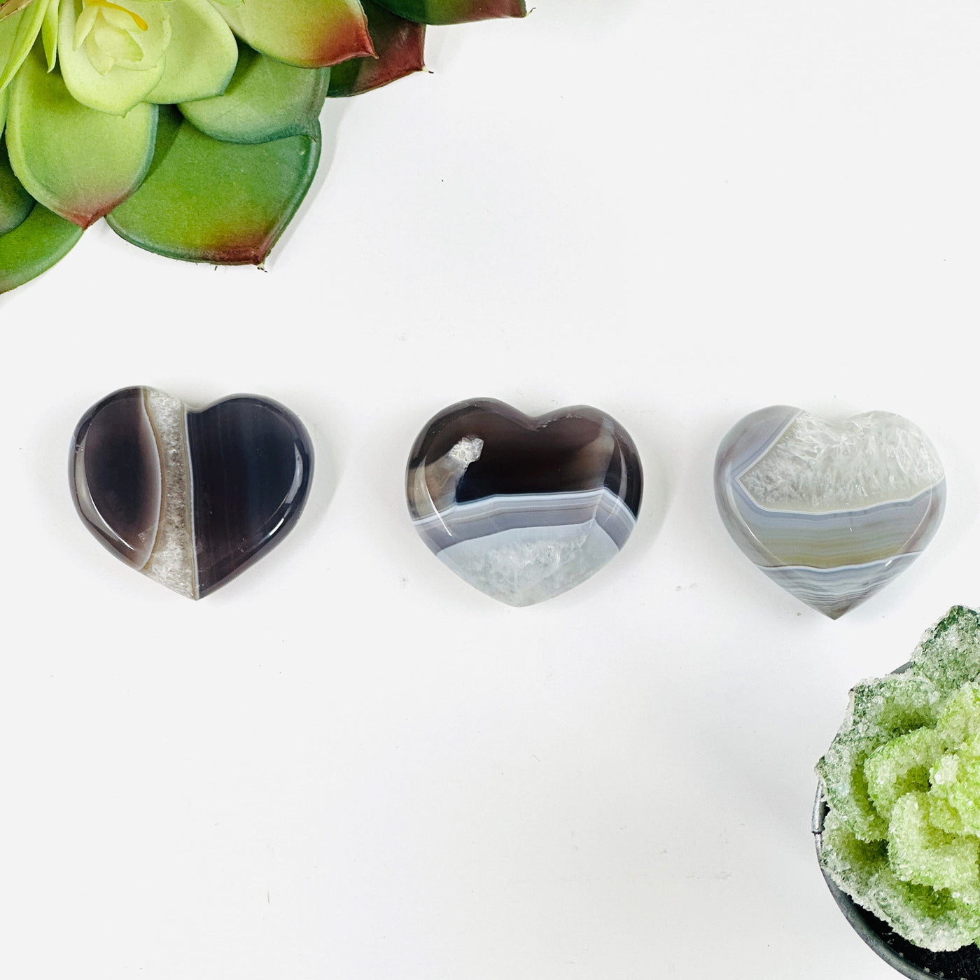 Natural agate heart slices with decorations in the background
