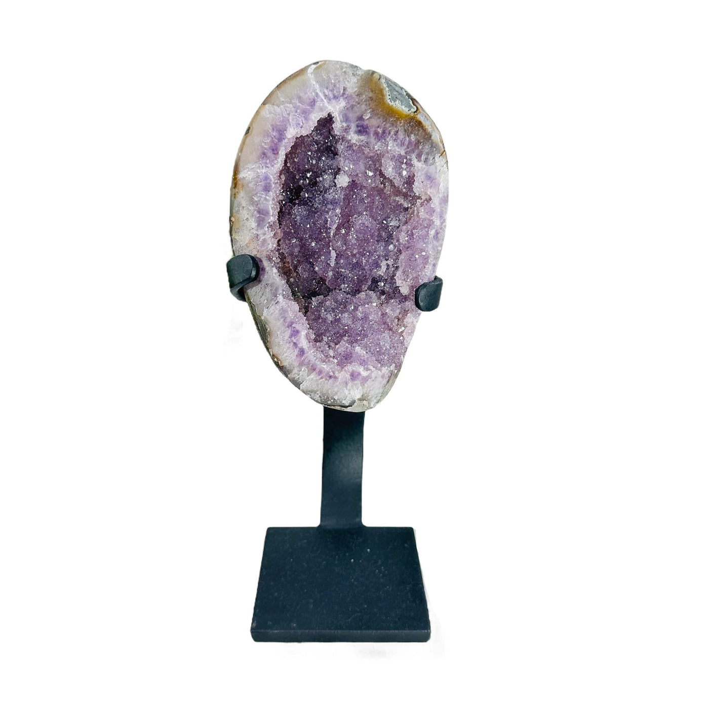 amethyst geode on stand on white background