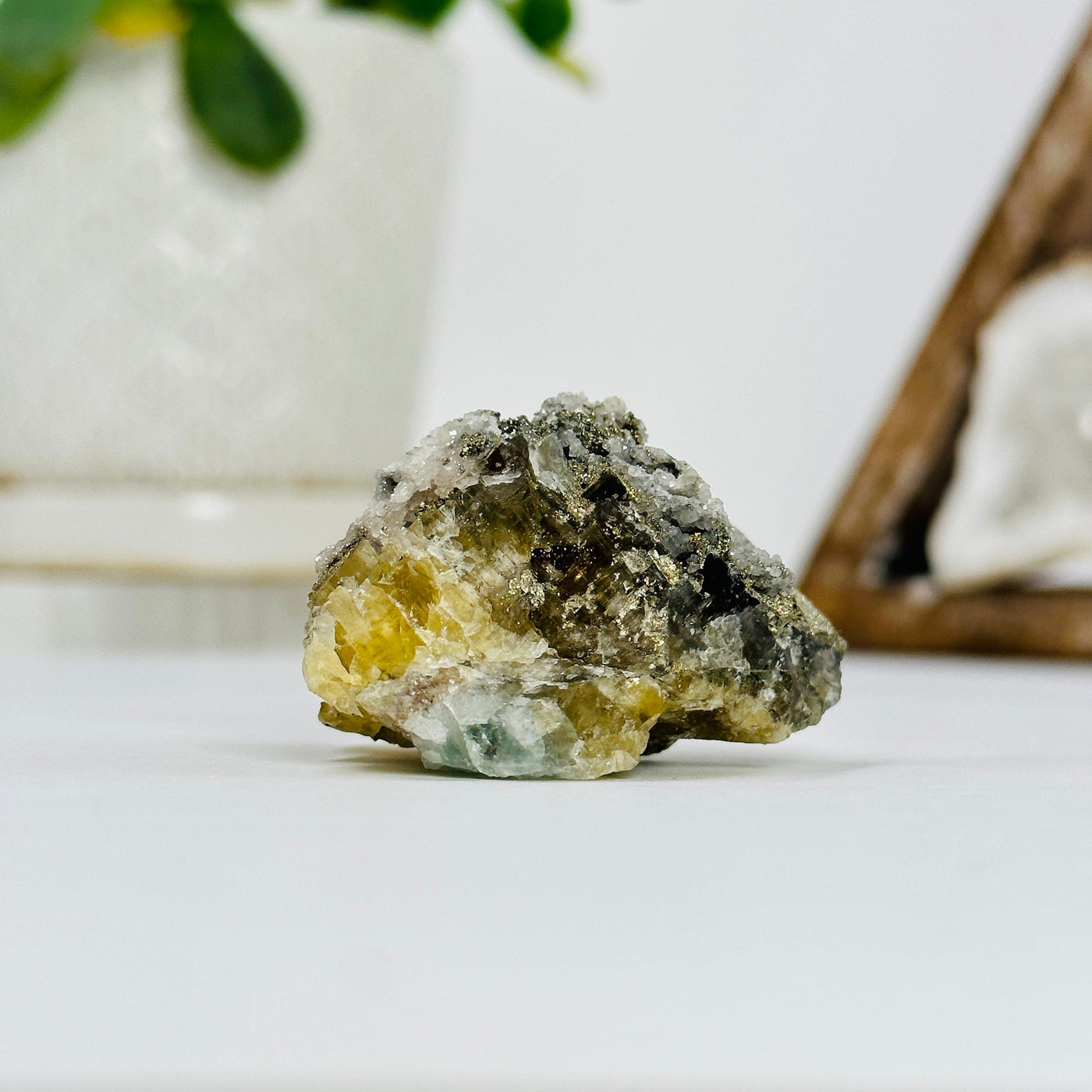 epidote with pyrite growth with decorations in the background