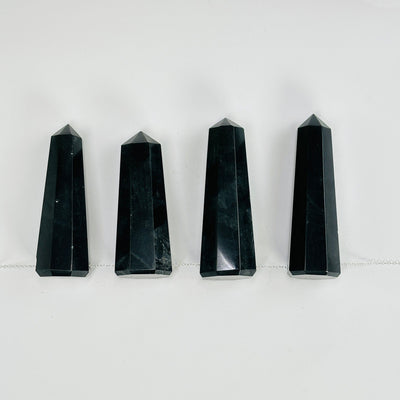 onyx obelisk points with a chain through them on white background