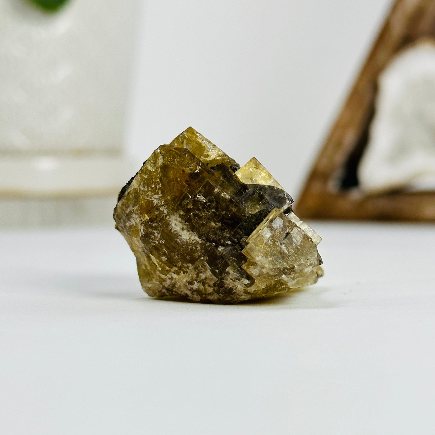side view of epidote cluster with decorations in the background
