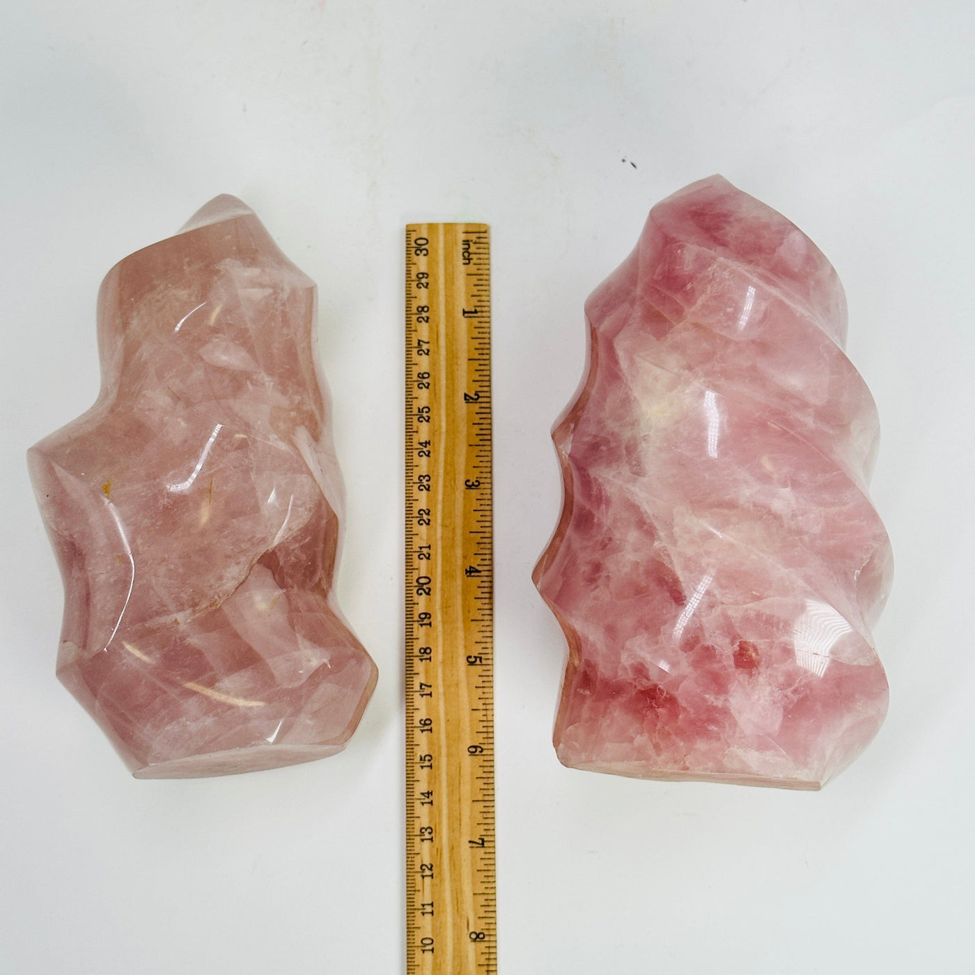 rose quartz flame towers next to a ruler for size reference
