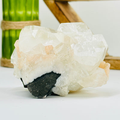 apophyllite with calcite cluster with decorations in the background
