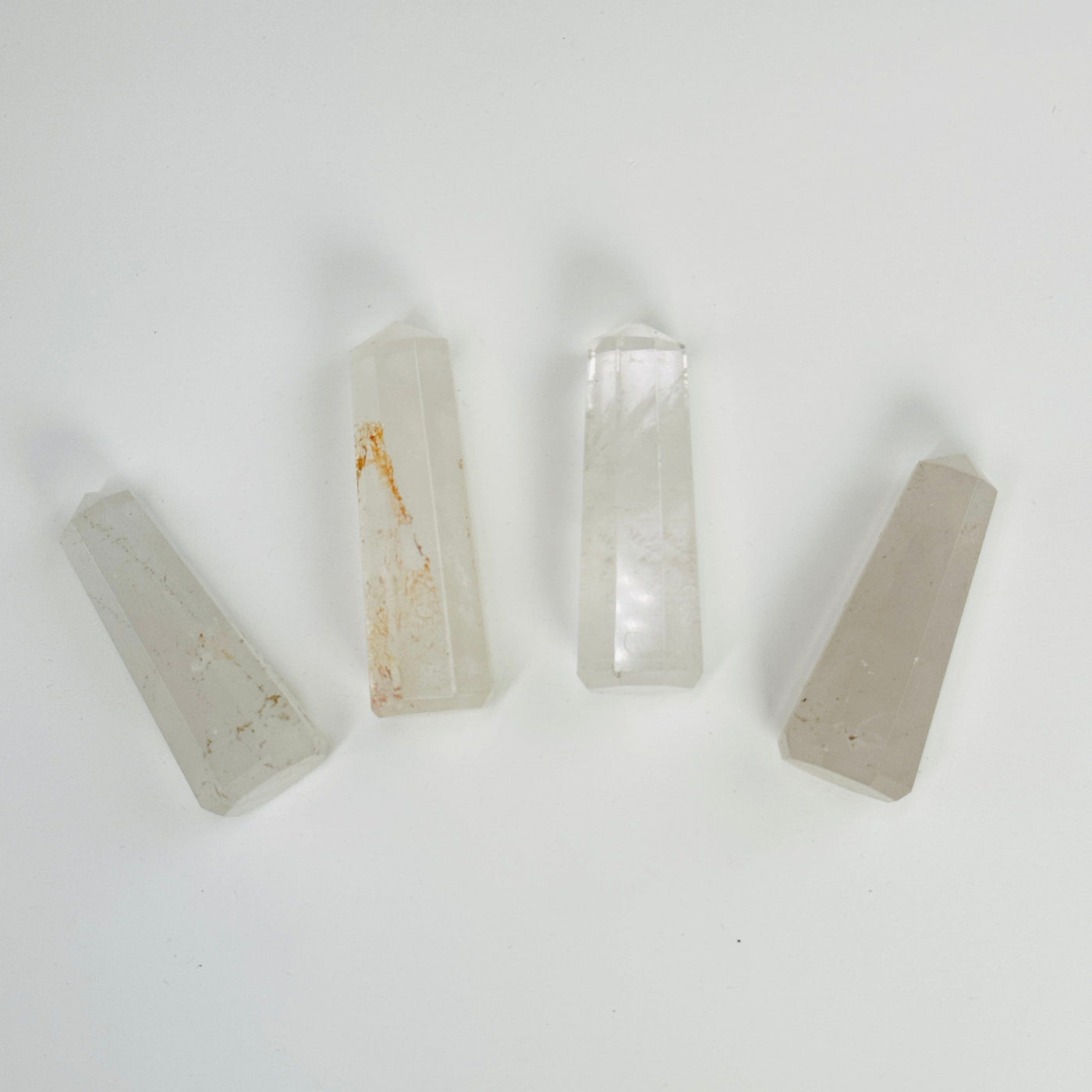 crystal quartz obelisk points on white background