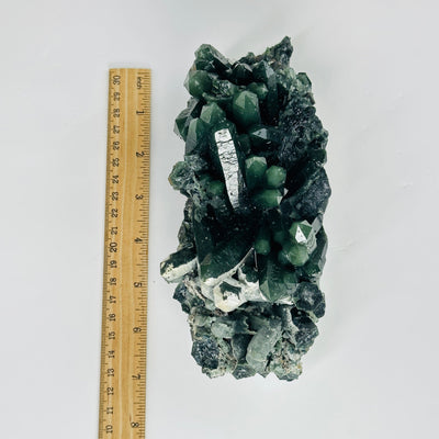 hedenbergite cluster next to a ruler for size reference