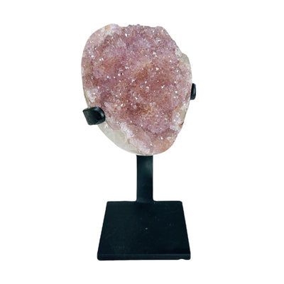 polished amethyst with stand on white background