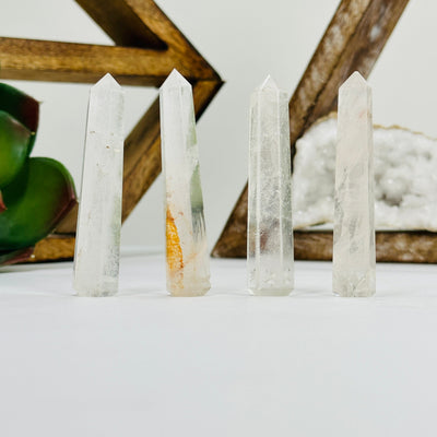 crystal quartz think obelisks drilled with decorations in the background