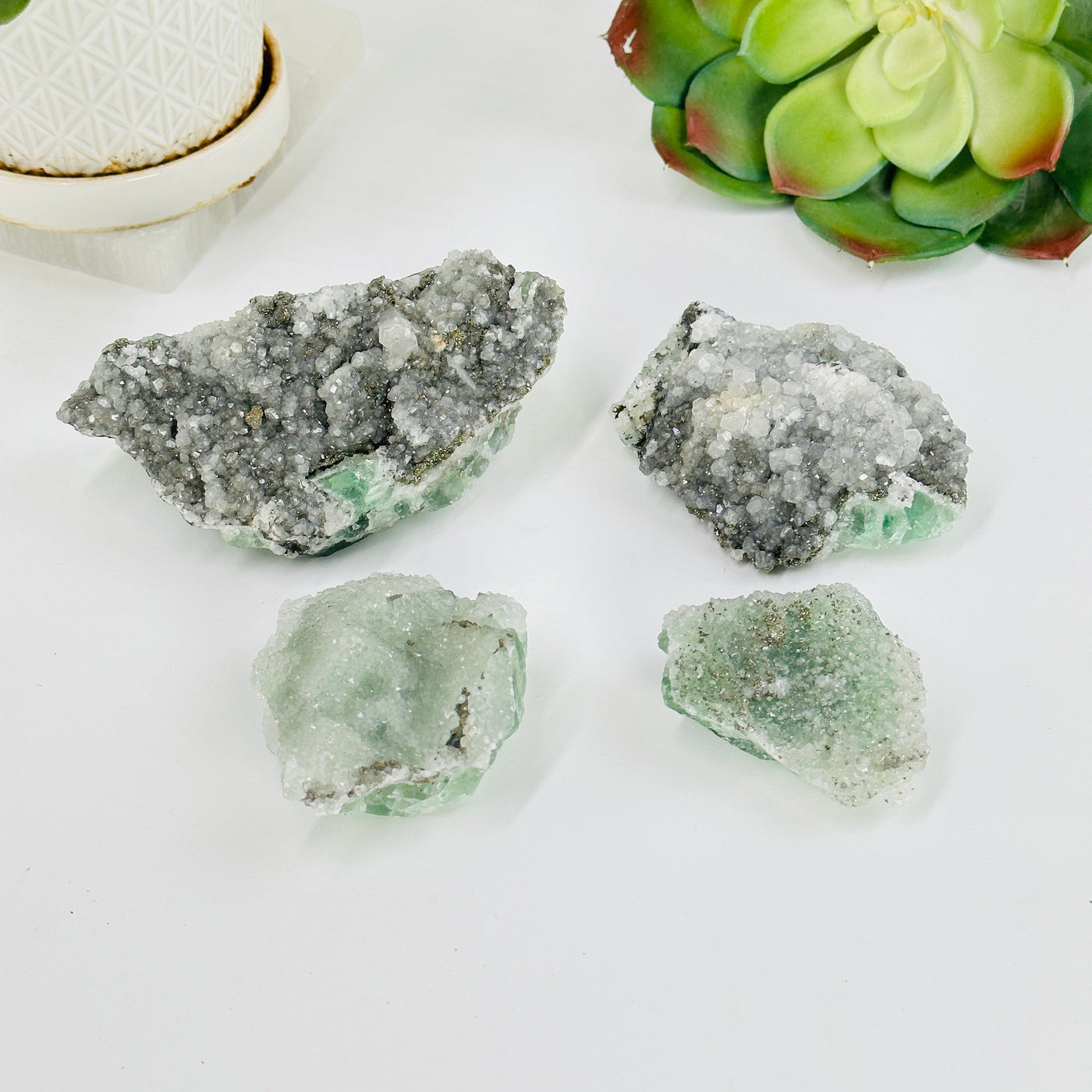 4 fluorite with pyrite and crystal quartz growth with decorations in the background