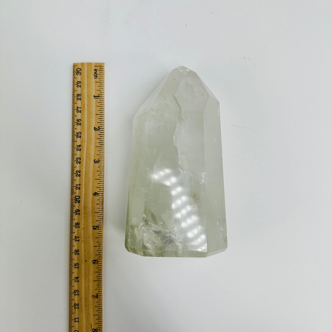crystal quartz point next to a ruler for size reference