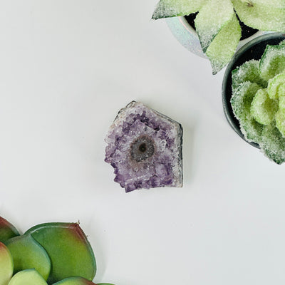amethyst stalactite cluster with decorations in the background