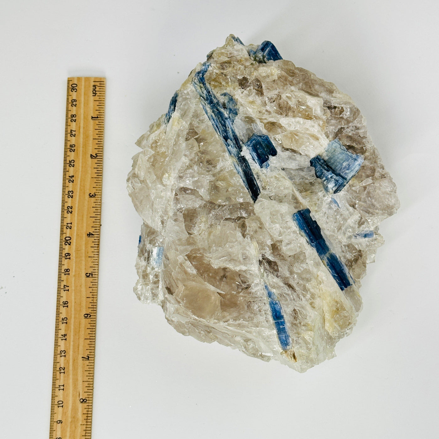 kyanite on matrix next to a ruler for size reference