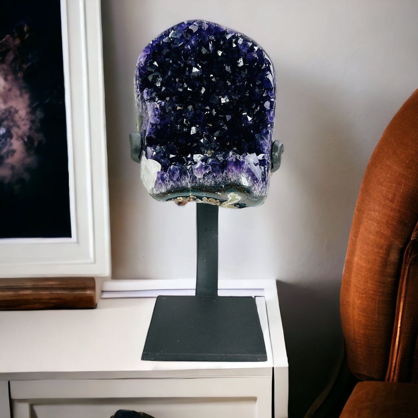 amethyst on stand with decorations in the background