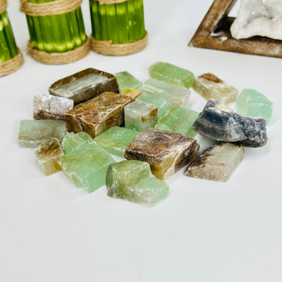 green calcite pieces with decorations in the background