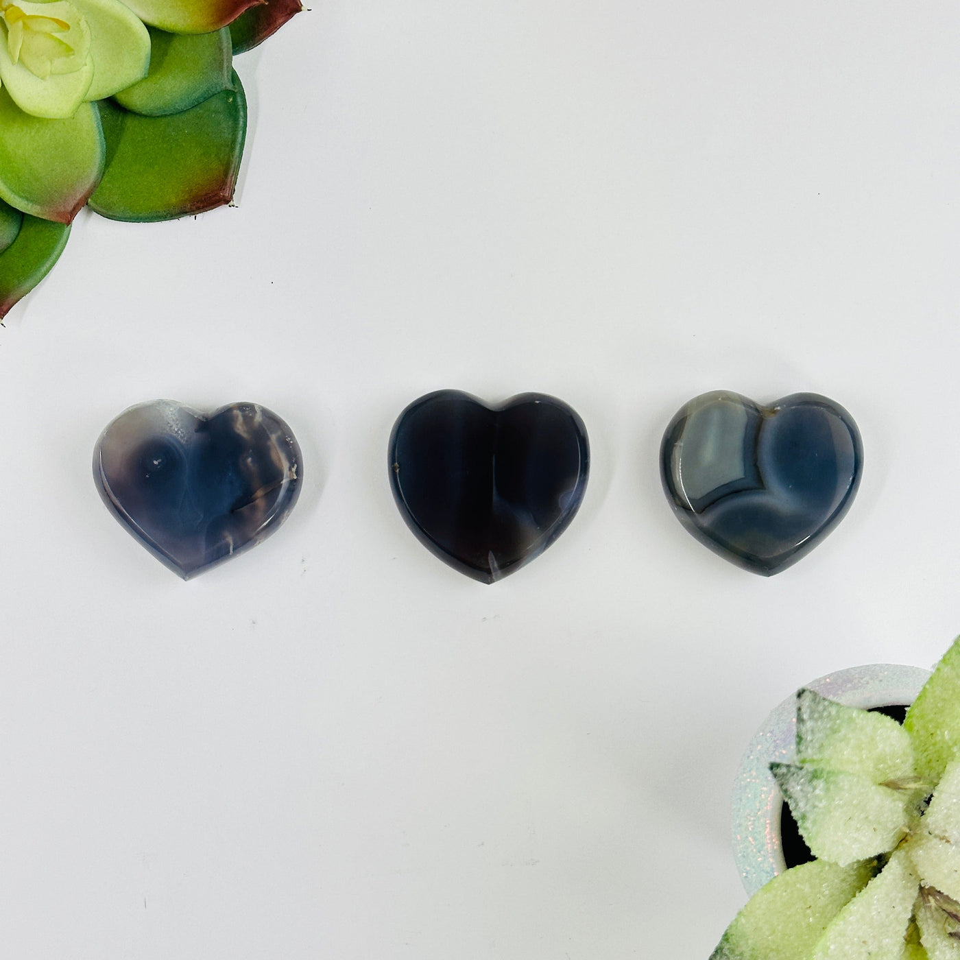 Natural agate heart slices with decorations in the background