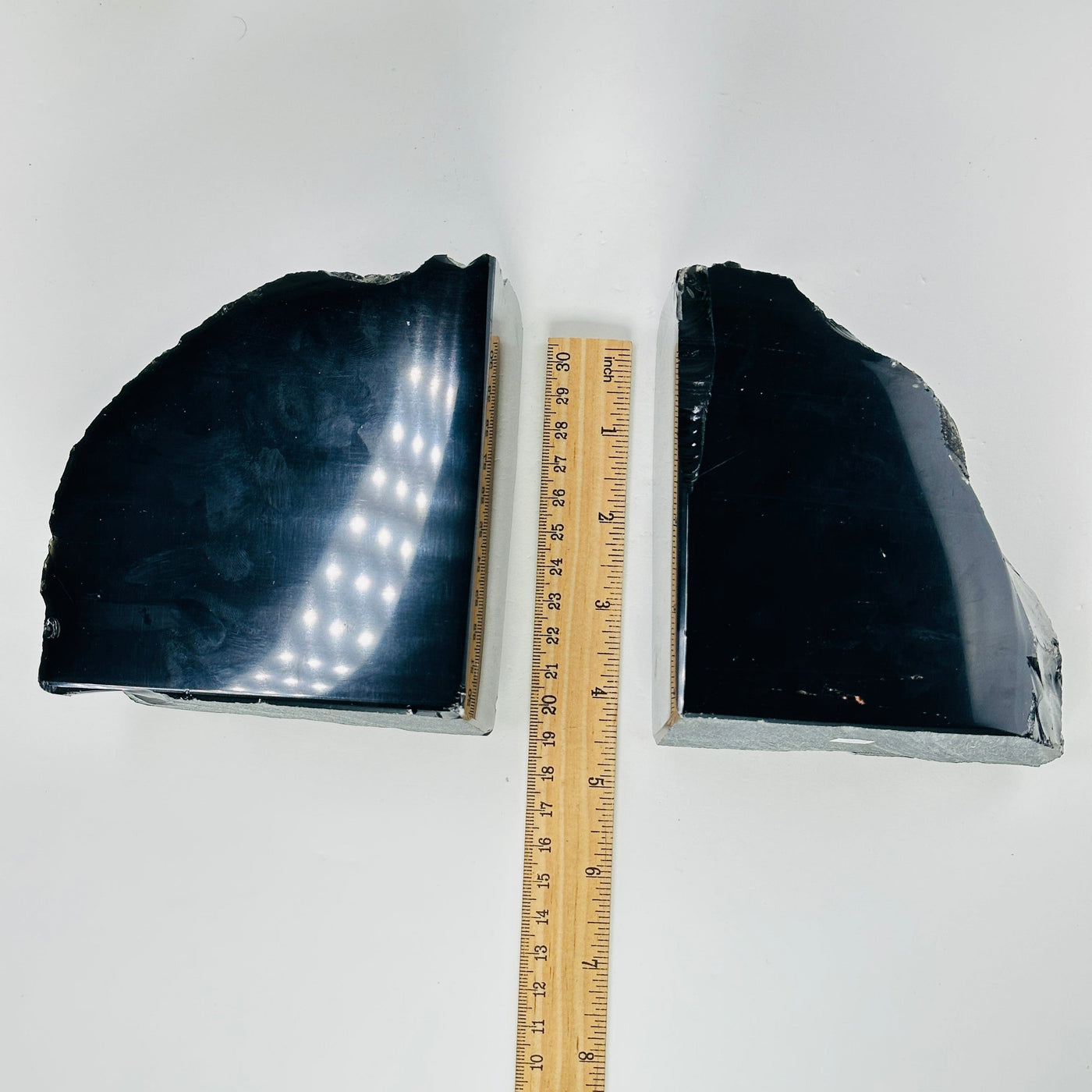 obsidian bookends next to a ruler for size reference