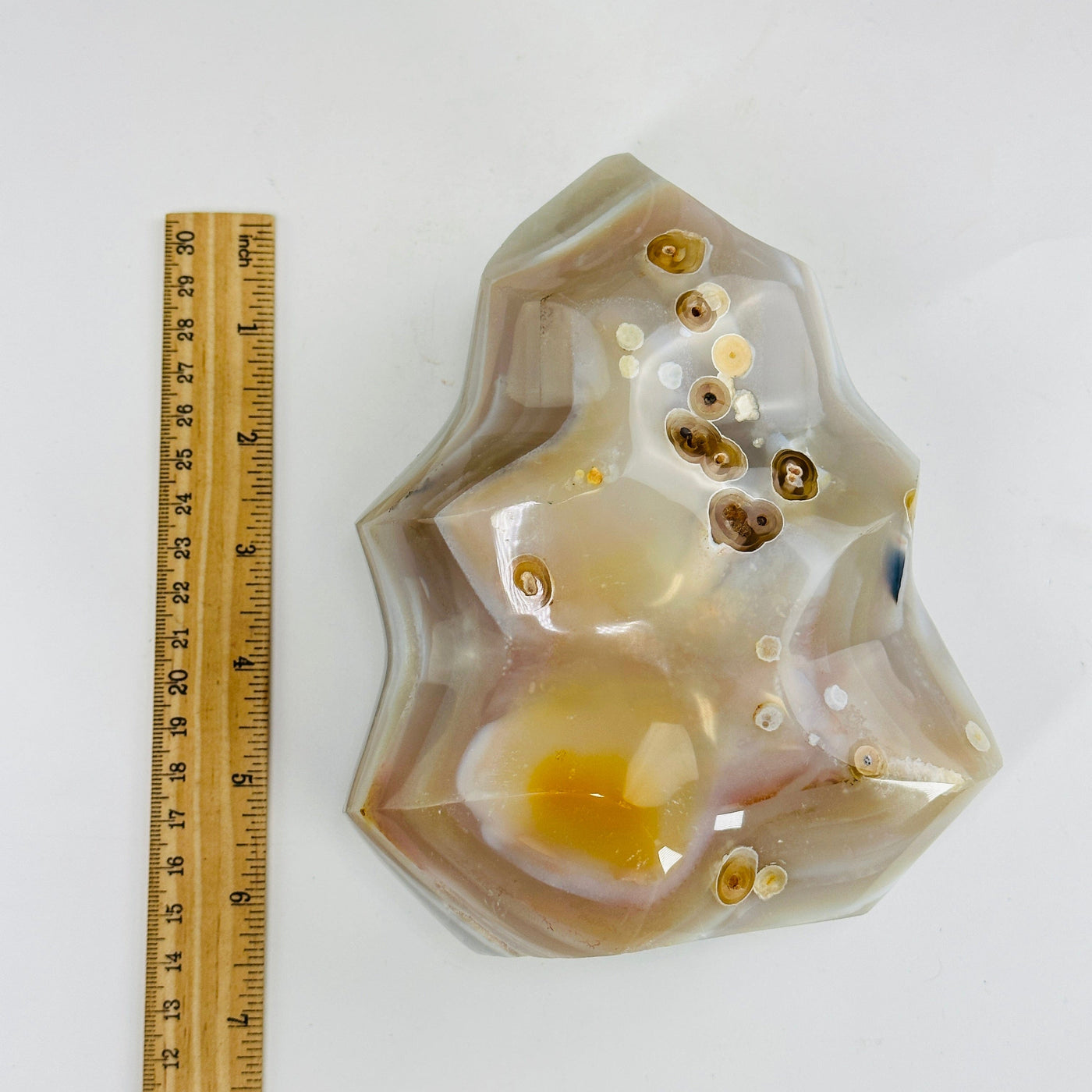 natural agate flame tower next to a ruler for size reference
