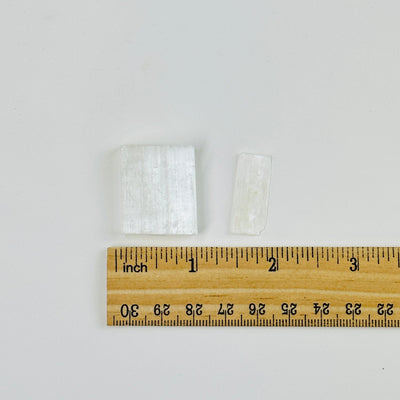 2 selenite chips next to a ruler for size reference