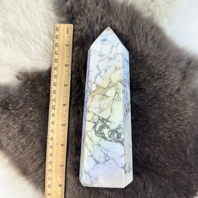 white howlite aura tower next to a ruler for size reference