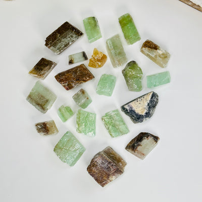 green calcite pieces on white background