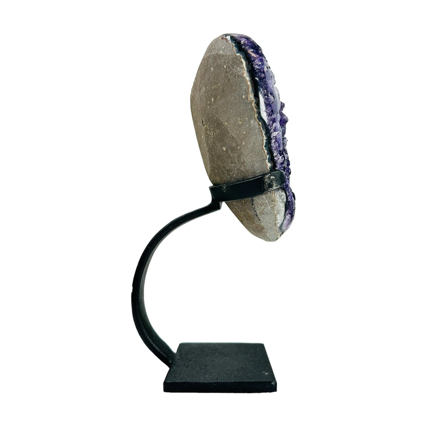 semi polished amethyst on stand on white background