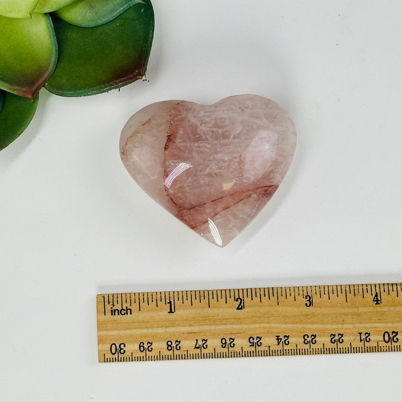 hematoid quartz heart next to a ruler for size reference
